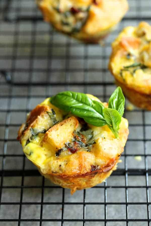 Close-up photo of a Muffin Pan Strata with Basil and Sun-Dried Tomatoes on cooking rack.