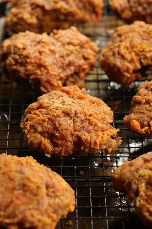 Close-up of fried chicken on rack after frying.