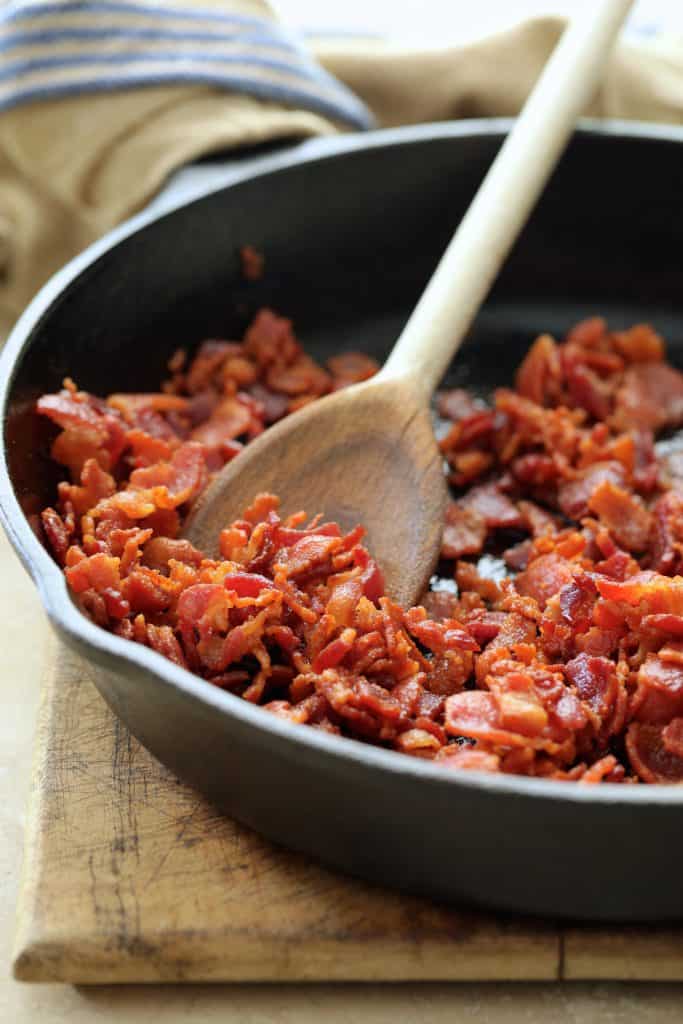 Photo of cooked bacon in cast iron skillet.