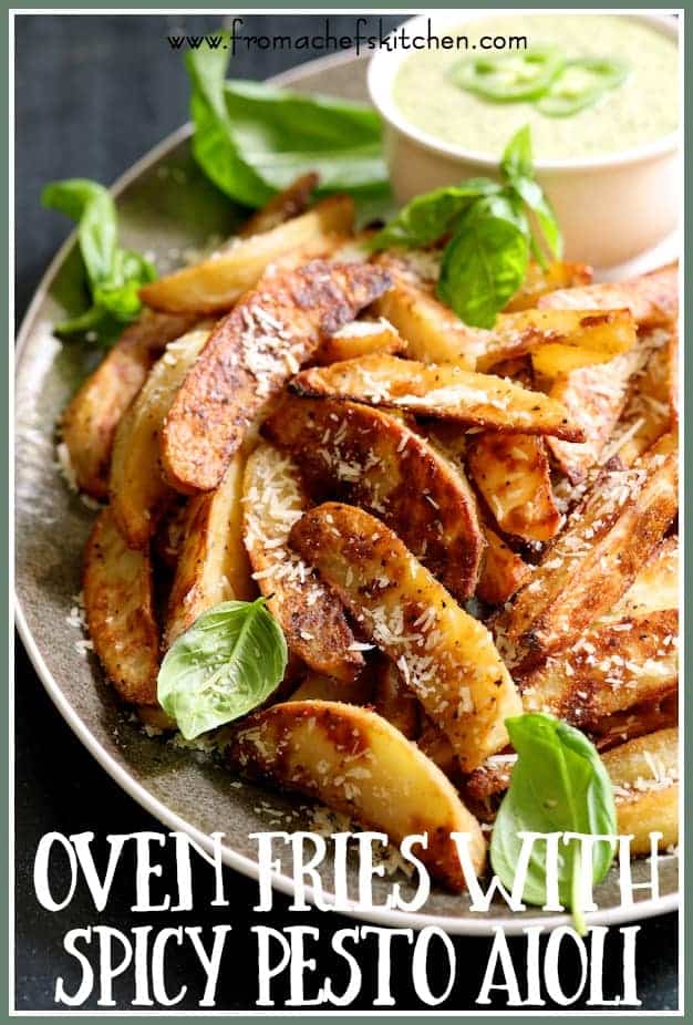 Pinterest graphic for Oven Fries with Spicy Pesto Aioli showing them on a gray-rimmed platter with pesto in a white bowl.