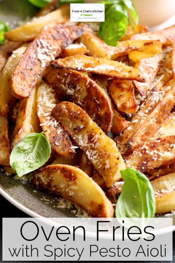 Pinterest graphic for Oven Fries with Spicy Pesto Aioli showing them on a gray-rimmed platter garnished with fresh basil leaves.