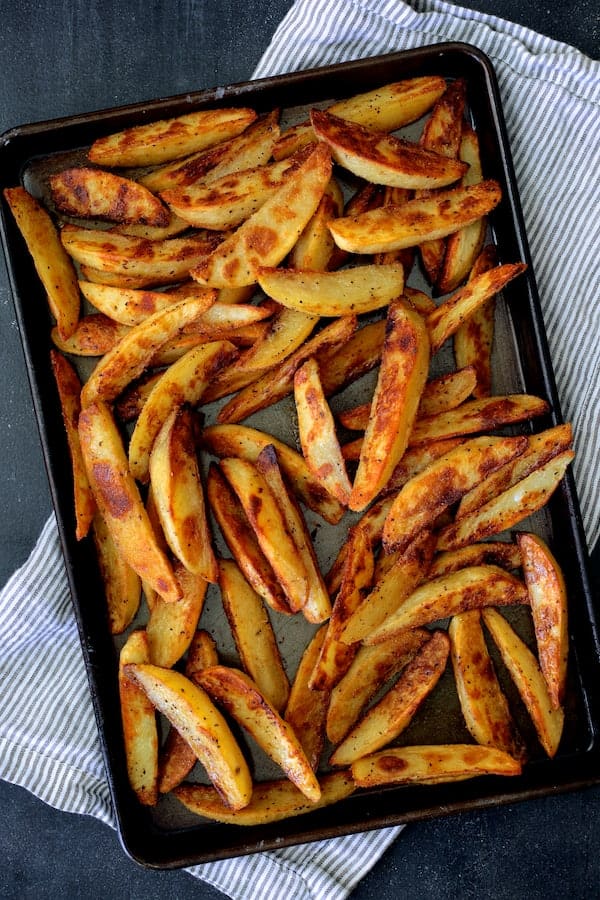 Photo of cooked oven fries on baking sheet.