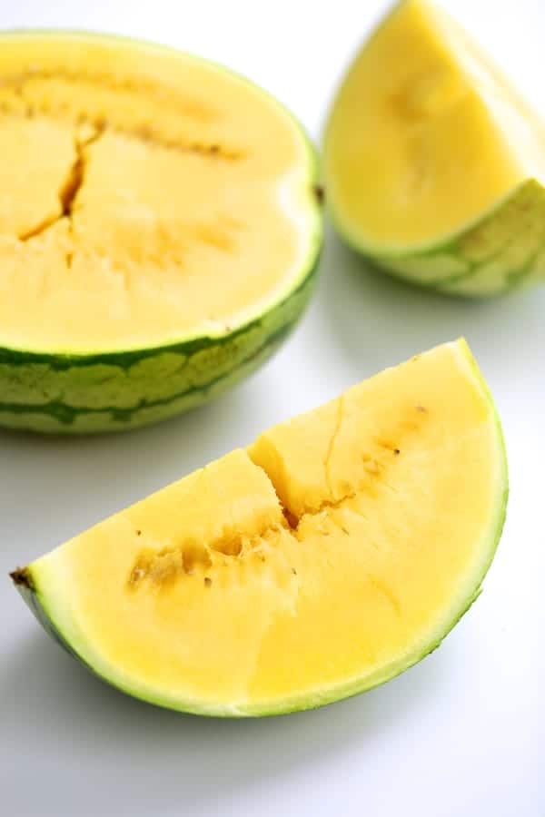 Photo of yellow watermelon cut into pieces.