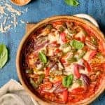 Italian Sausage and Bell Pepper Polenta Bake fresh out of the oven on wooden trivet.