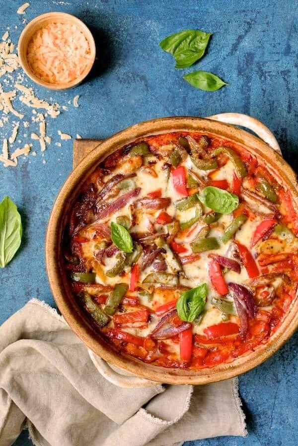 Italian Sausage and Bell Pepper Polenta Bake fresh out of the oven on wooden trivet.