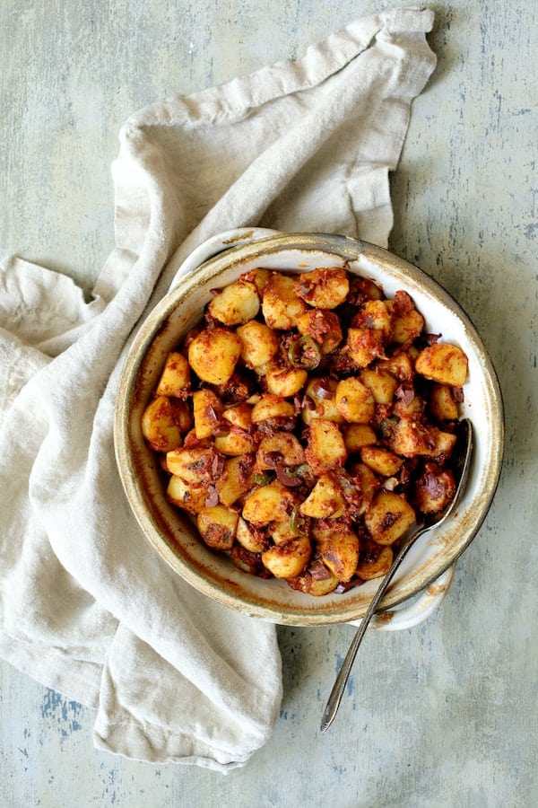 Photo of Patatas Bravas Chilenos in clay serving dish.