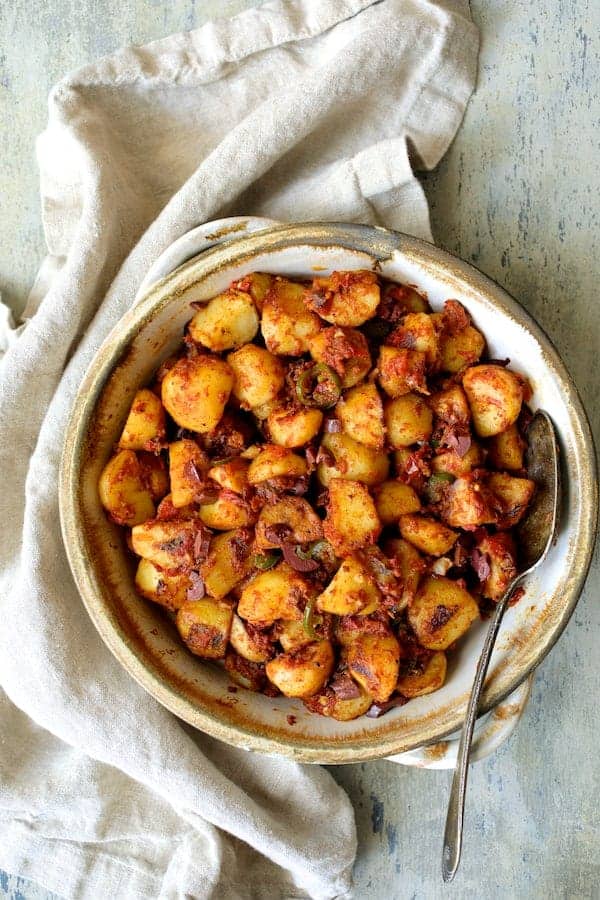 Photo of Patatas Bravas Chilenos in clay serving dish.