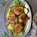 Moroccan Chicken Tagine with Butternut Squash Chickpeas and Olives on gray-rimmed platter.