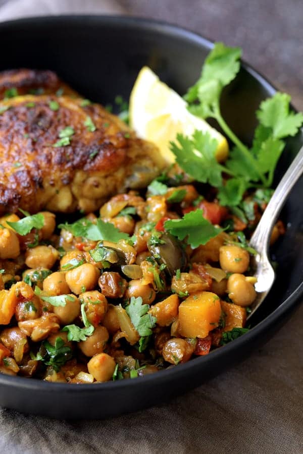 Moroccan Chicken Tagine with Butternut Squash Chickpeas and Olives - Close-up shot of butternut squash, chickpea and olive combination in black bowl