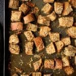 Whole grain croutons on baking sheet.