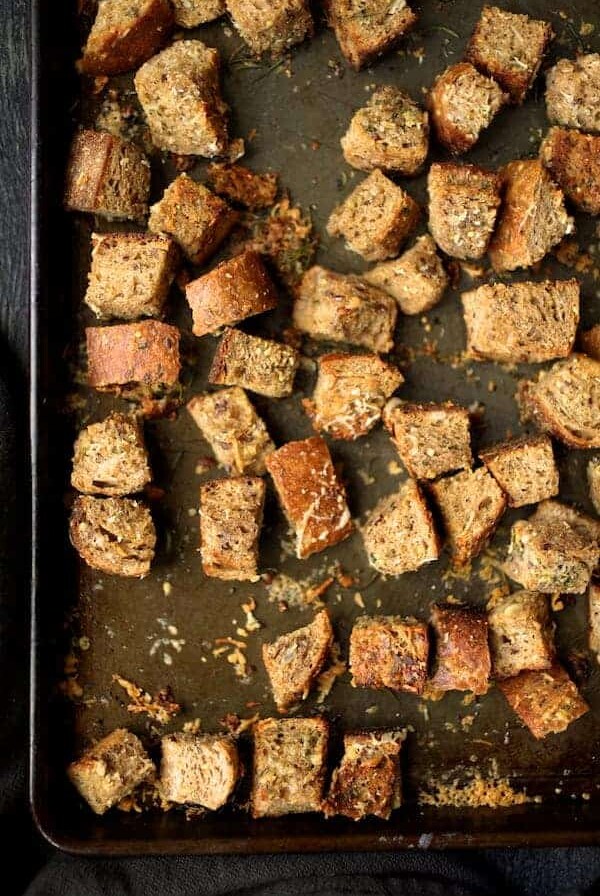 Whole grain croutons on baking sheet.