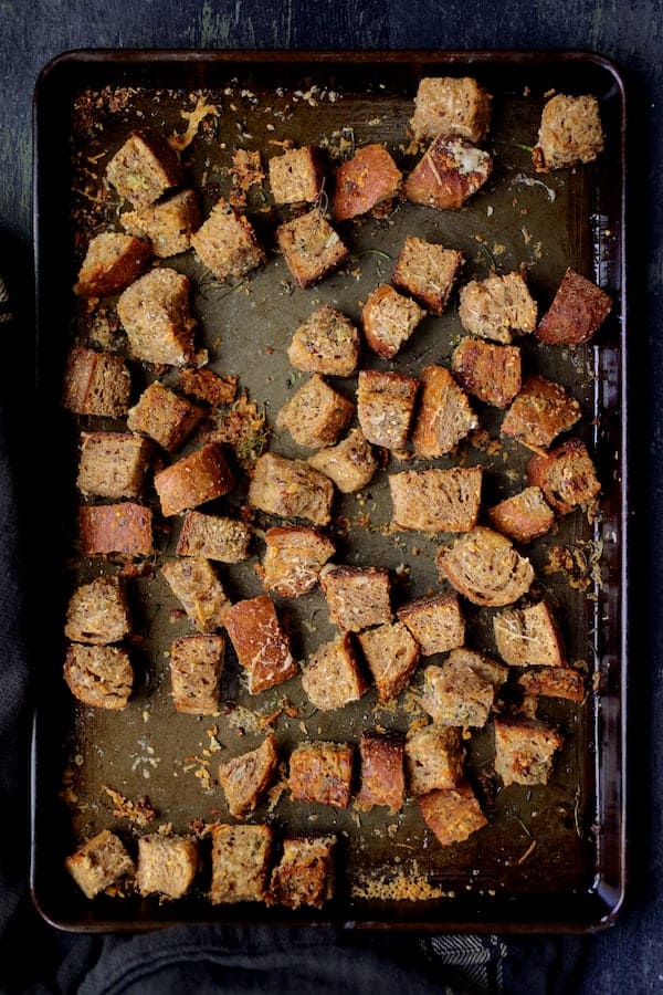 Photo of Whole Grain Thyme Rosemary and Parmesan Croutons on baking sheet.