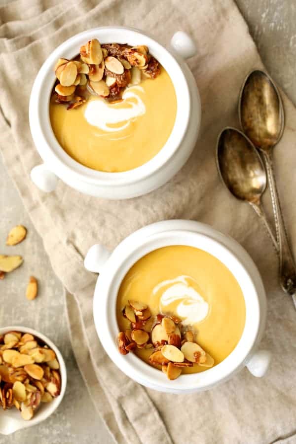 Photo of Pumpkin Soup with Marsala and Mascarpone in white bowls on beige napkin.
