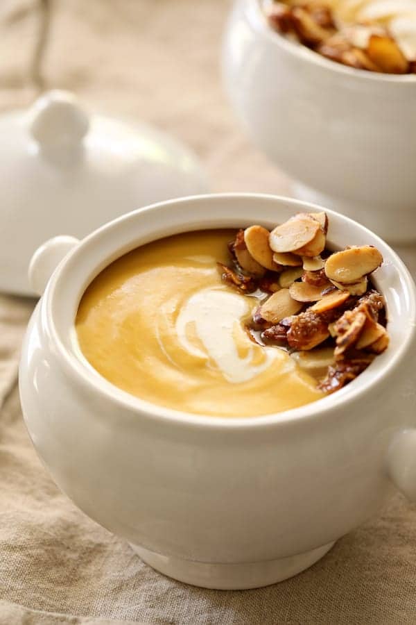 Photo of Pumpkin Soup with Marsala and Mascarpone in white soup bowl with almond topping.