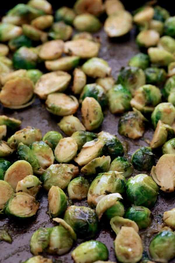 Photo of roasted Brussels sprouts on baking sheet.