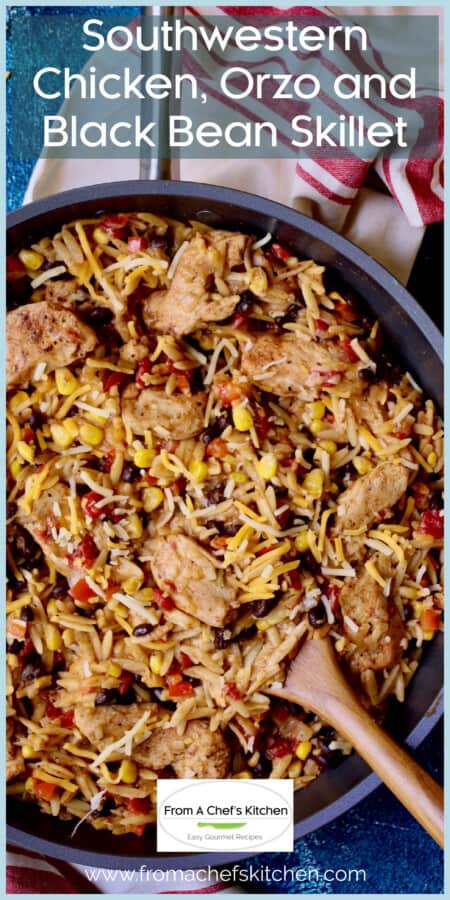 Southwestern Chicken Orzo and Black Bean Skillet with wooden stirring spoon.