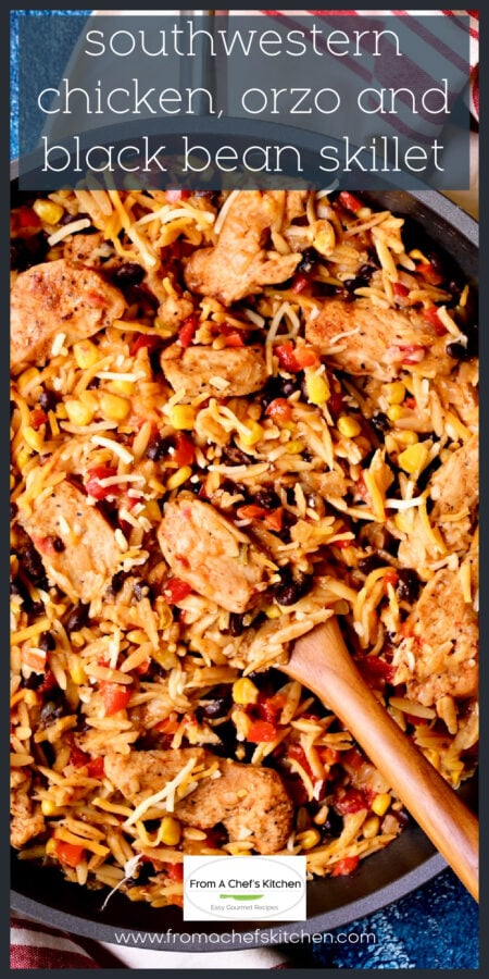 Southwestern Chicken Orzo and Black Bean Skillet with wooden stirring spoon.