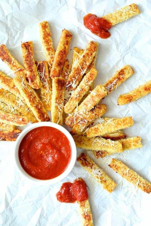 Spaghetti Squash Fries on white paper with marinara sauce.