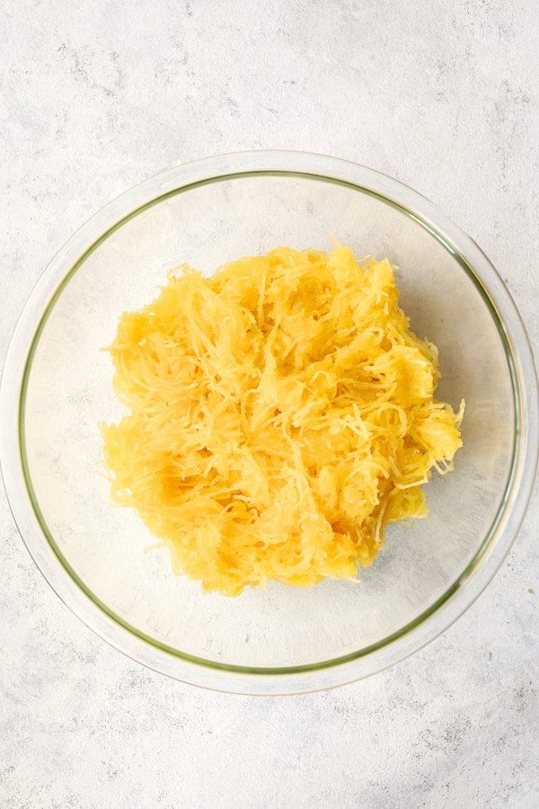 Photo of cooked spaghetti squash in glass bowl.