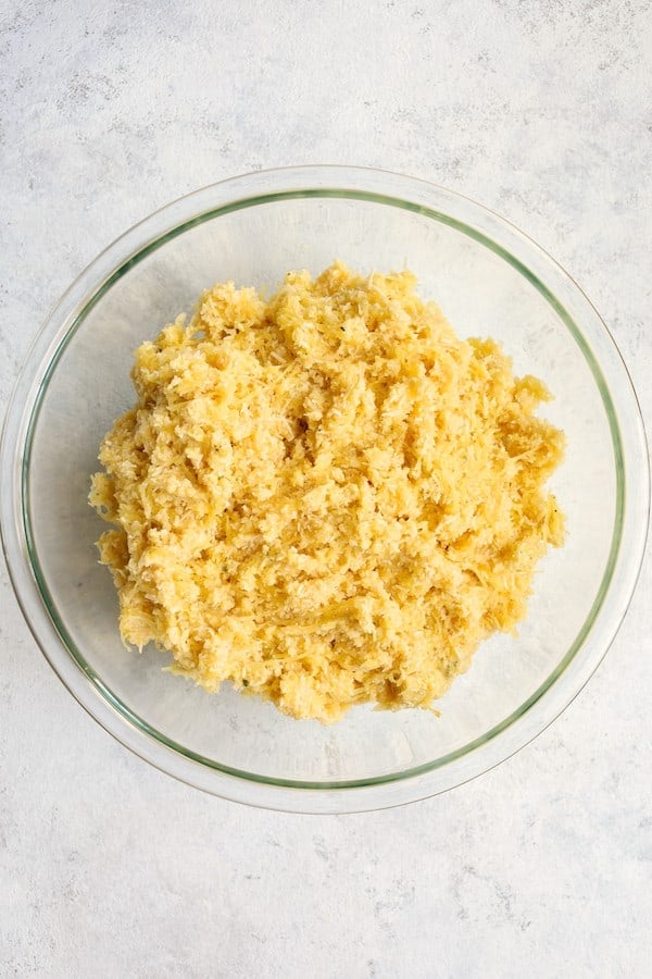 Photo of Spaghetti Squash Fries ingredients combined in glass bowl.