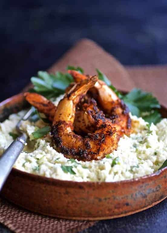 Cauliflower Gouda Grits and Blackened Shrimp in earthenware bow.