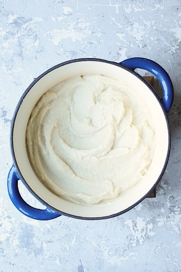 Photo of pureed cauliflower in blue Dutch oven.