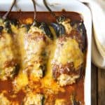 Chicken Brown Rice and Cheese-Stuffed Poblanos in white baking dish.