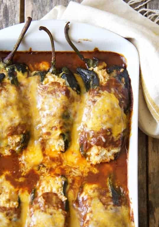 Chicken Brown Rice and Cheese-Stuffed Poblanos in white baking dish.