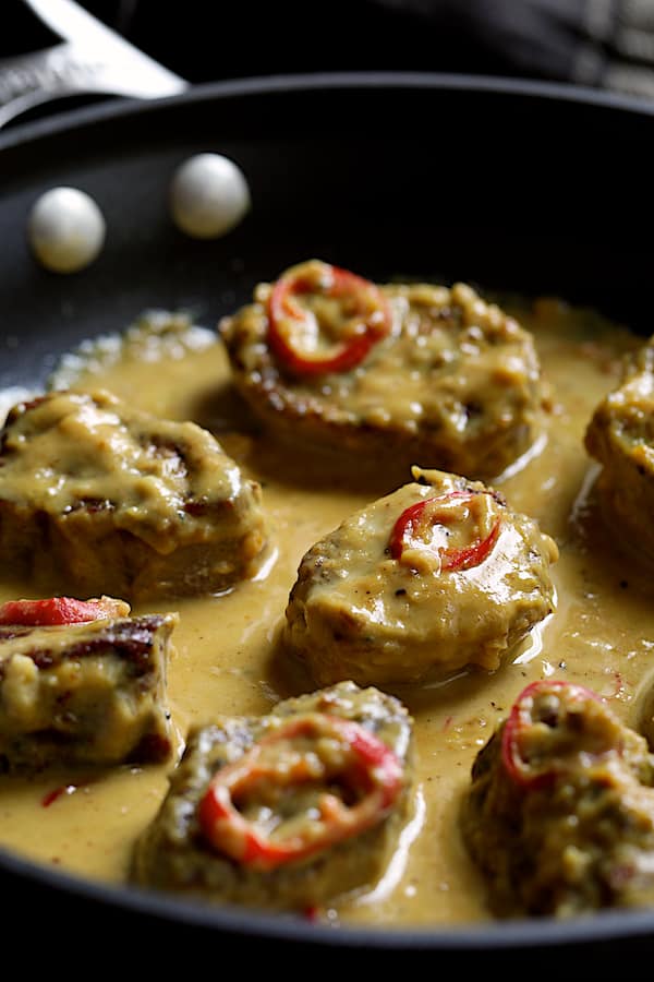 Photo of sauced Spicy Tahini Pork Medallions in skillet.