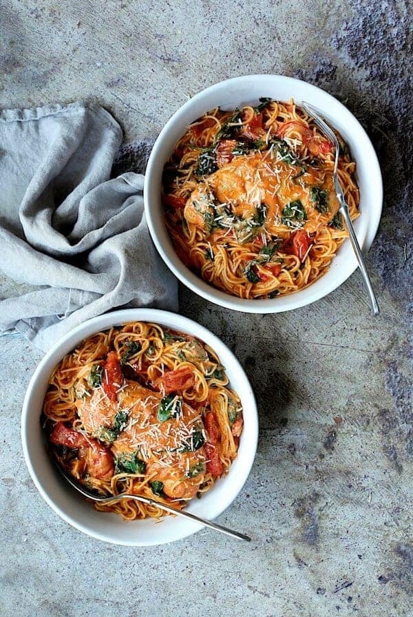 Two bowls Chicken in Rosa Sauce with Roasted Red Bell Pepper and Spinach in white serving bowls.