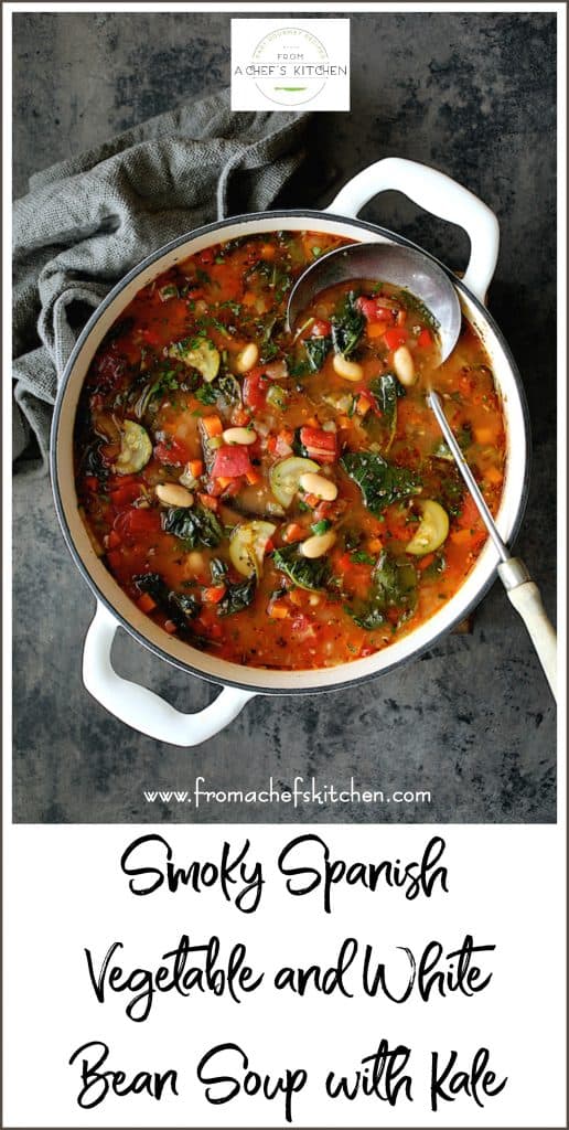 Pinterest graphic for Smoky Spanish Vegetable and White Bean Soup with Kale showing it in a white Dutch oven.