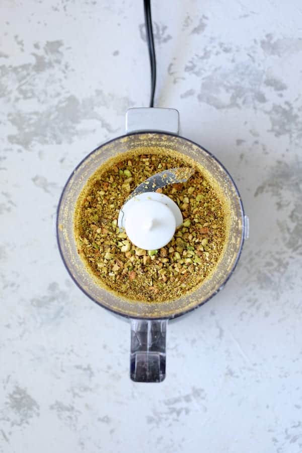 Photo of chopped pistachios in mini food processor.