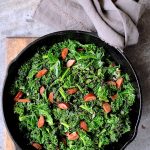 Spicy Sautéed Kale with Andouille Sausage in cast iron skillet.