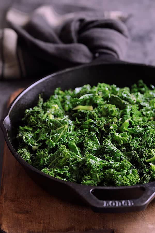 Photo of sauteed kale in cast iron skillet.