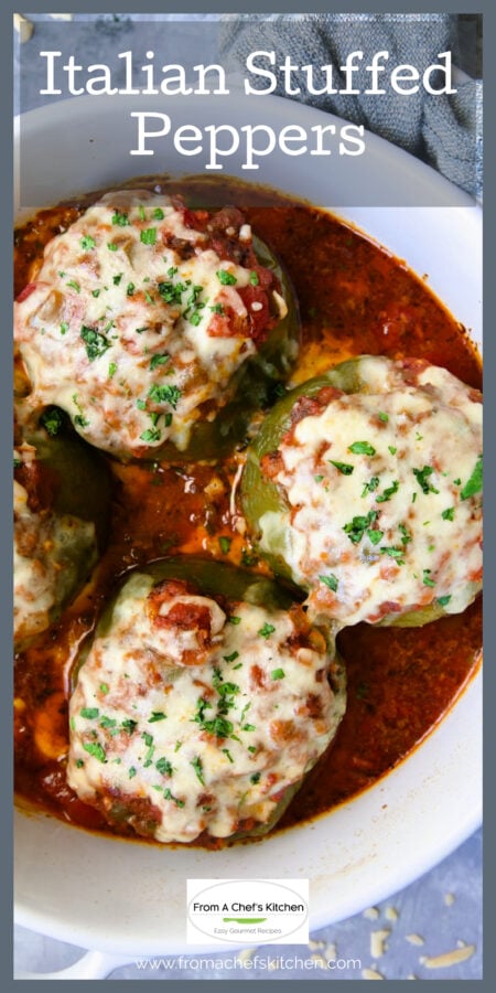 Three Italian Stuffed Peppers in white round baking dish garnished with fresh parsley.
