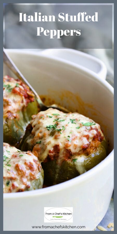Three Italian Stuffed Peppers in white round baking dish with serving spoon.
