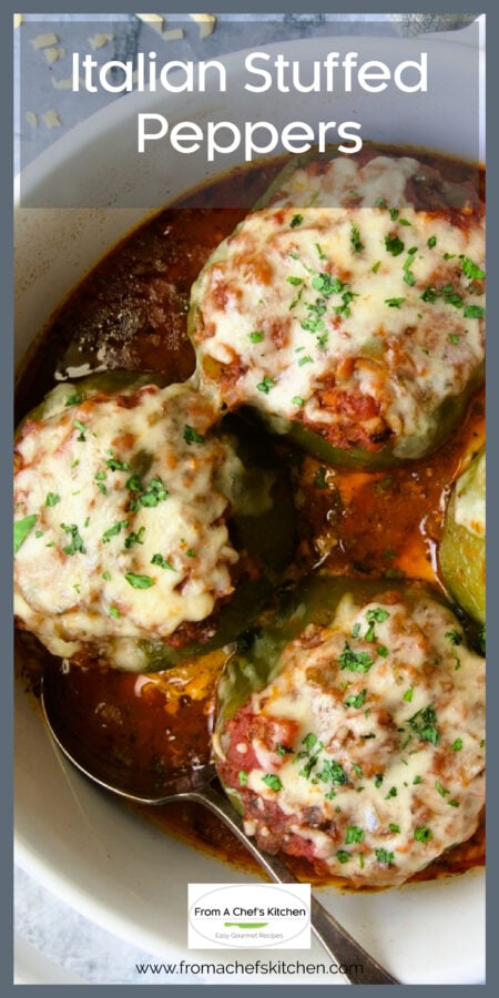 Three Italian Stuffed Peppers in white round baking dish with serving spoon.