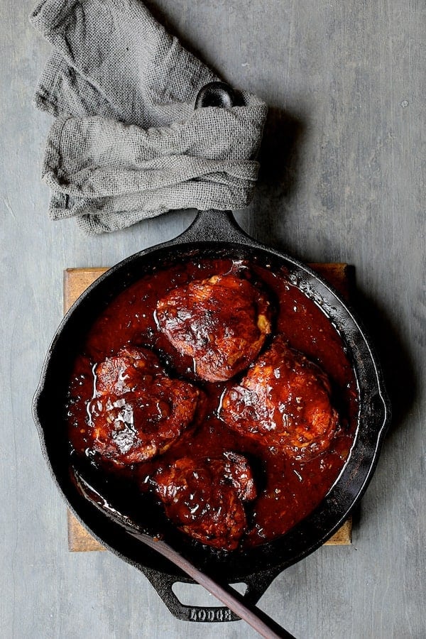 Photo of Korean Braised Chicken Thighs in cast iron skillet before being garnished.
