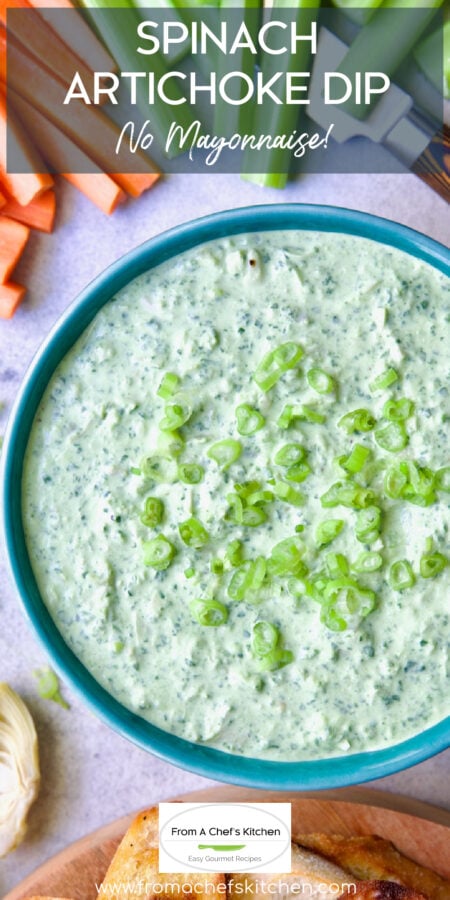 Pinterest graphic for Spinach Artichoke Dip No Mayo showing it in a bright blue bowl with carrot sticks, celery sticks and toasted baguette slices.