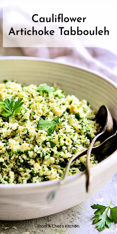 Pinterest graphic for Cauliflower Artichoke Tabboule showing it in a white serving bowl with serving utensils.