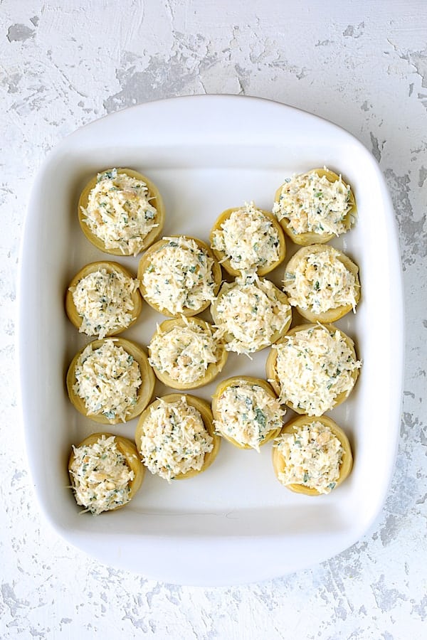 Photo of stuffed artichoke bottoms before being baked.