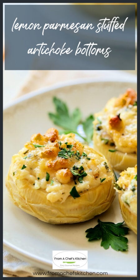 Three lemon parmesan stuffed artichoke bottoms on white plate garnished with fresh parsley.