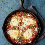 Shakshuka with Red Lentils and Feta Cheese in a cast iron skillet.