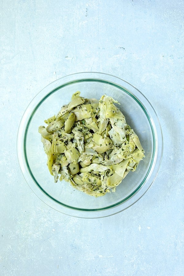 Photo of artichoke combination in glass mixing bowl.