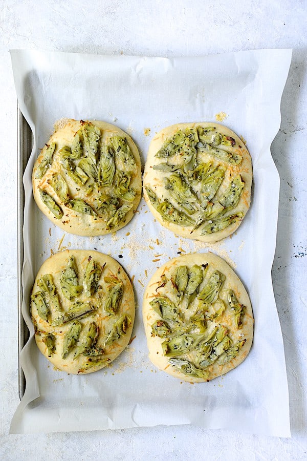 Photo of baked Artichoke Focaccia with Rosemary on baking sheet.