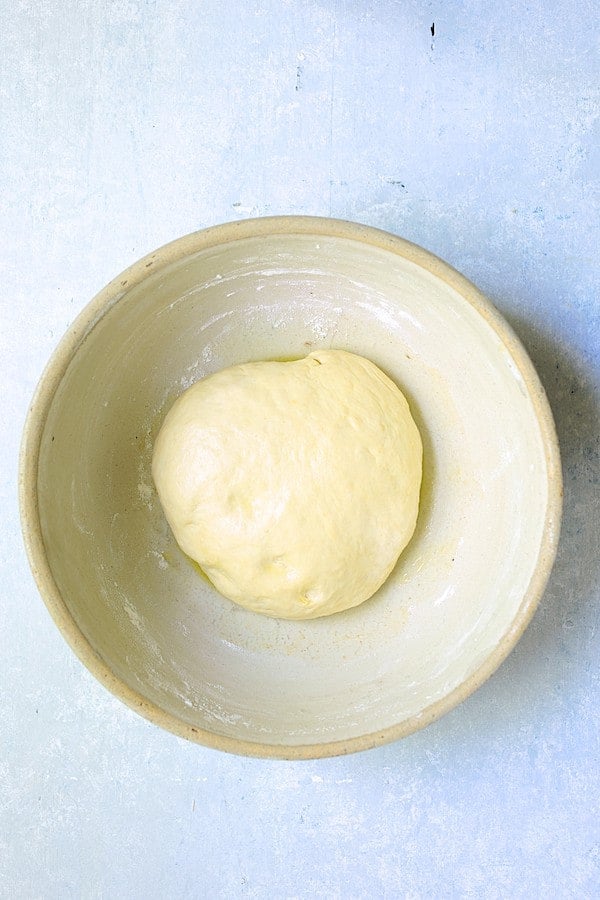 Photo of focaccia dough in stoneware bowl before rising.