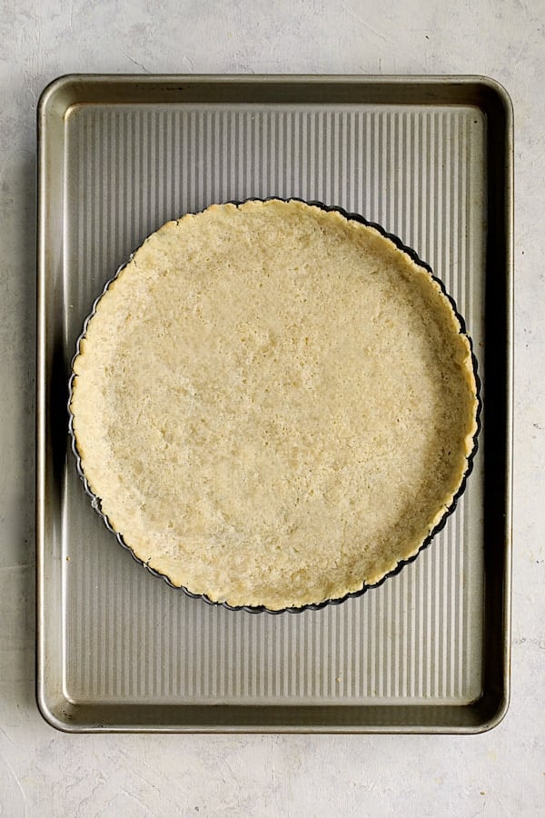 Photo of baked tart crust on baking sheet.