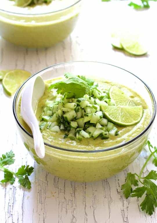 Cold Thai Cucumber Avocado Soup with Cucumber Relish in glass bowl.