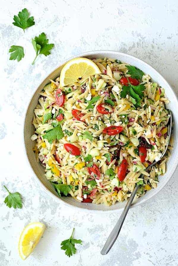 Greek Orzo Pasta Salad in white serving bowl.