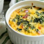 One serving of Hash Brown Frittata with Kale, Bacon and Cheddar in a white ramekin.